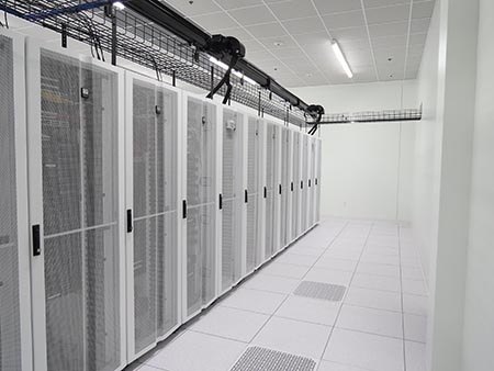 Data hall with raised floor and white server cabinets in Southfield, Michigan